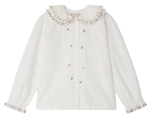 The Bonpoint Girls' Janeke Blouse features a ruffled embroidered collar, pleated details, button front, and gathered cuffs, crafted from soft organic cotton.