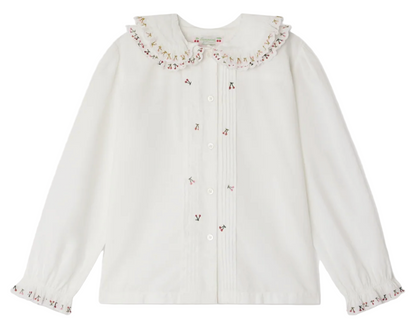The Bonpoint Girls' Janeke Blouse features a ruffled embroidered collar, pleated details, button front, and gathered cuffs, crafted from soft organic cotton.