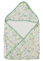 Timo & Violet Hooded Bath Towel: white interior, green trim, and a floral-and-bird print in green, blue, and pink—ideal as a kids' bath or baby swim towel.