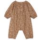 The Baby Girls' Jia Smocked Jumpsuit in Liberty Fabric by Bonpoint is a long-sleeved, floral romper with three white front buttons and elastic cuffs at the sleeves and ankles.