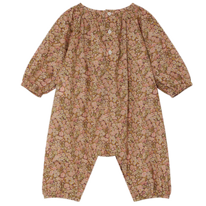 The Baby Girls' Jia Smocked Jumpsuit in Liberty Fabric by Bonpoint is a long-sleeved, floral romper with three white front buttons and elastic cuffs at the sleeves and ankles.