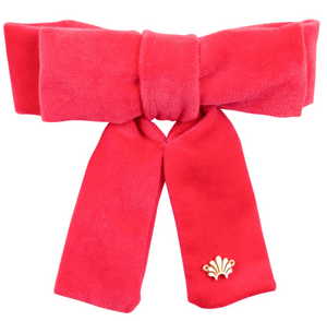 The TBBC x LELE Kids Antoinette Barret by The Beaufort Bonnet Company is a luxe red velvet bow with two long tails and a small gold emblem on the lower right tail, adding an elegant, signature touch.