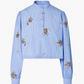 The Margot Top by Altuzarra features light blue striped cotton-poplin, a mandarin collar, front buttons, brown floral patterns, and stylish balloon sleeves.
