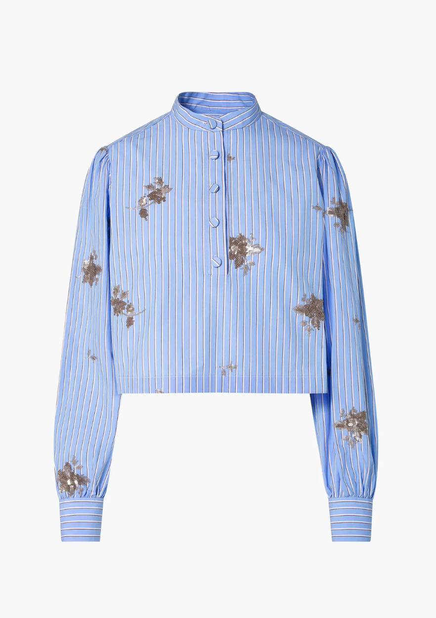 The Margot Top by Altuzarra features light blue striped cotton-poplin, a mandarin collar, front buttons, brown floral patterns, and stylish balloon sleeves.