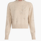 The Altuzarra Paulie Sweater is a beige long-sleeve knit crafted from virgin wool, detailed with embroidered floral designs, beaded embellishments, and finished with ribbed cuffs and hem.