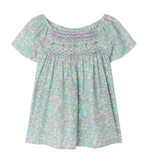 The Bonpoint Girls' Grenade Smocked Blouse features short sleeves, a loose fit, pastel floral Liberty fabric, and decorative chest smocking.