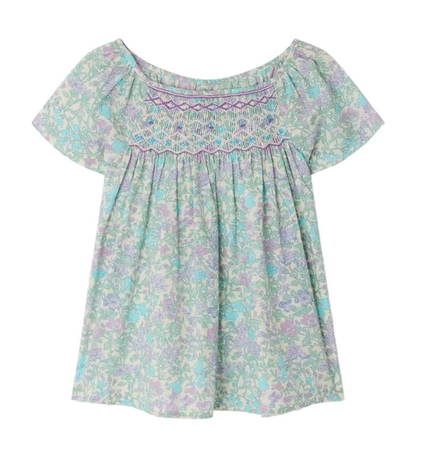 The Bonpoint Girls' Grenade Smocked Blouse features short sleeves, a loose fit, pastel floral Liberty fabric, and decorative chest smocking.