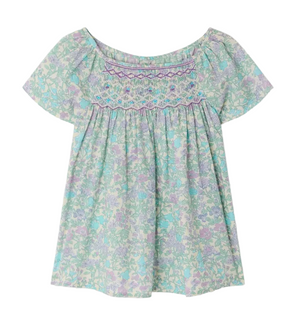 The Bonpoint Girls' Grenade Smocked Blouse features short sleeves, a loose fit, pastel floral Liberty fabric, and decorative chest smocking.