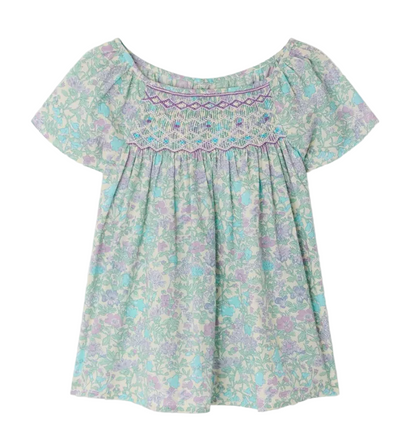 The Bonpoint Girls' Grenade Smocked Blouse features short sleeves, a loose fit, pastel floral Liberty fabric, and decorative chest smocking.