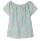 The Bonpoint Girls' Grenade Smocked Blouse is a short-sleeve, off-the-shoulder top made from organic cotton with a light blue, green, and purple floral print on white.