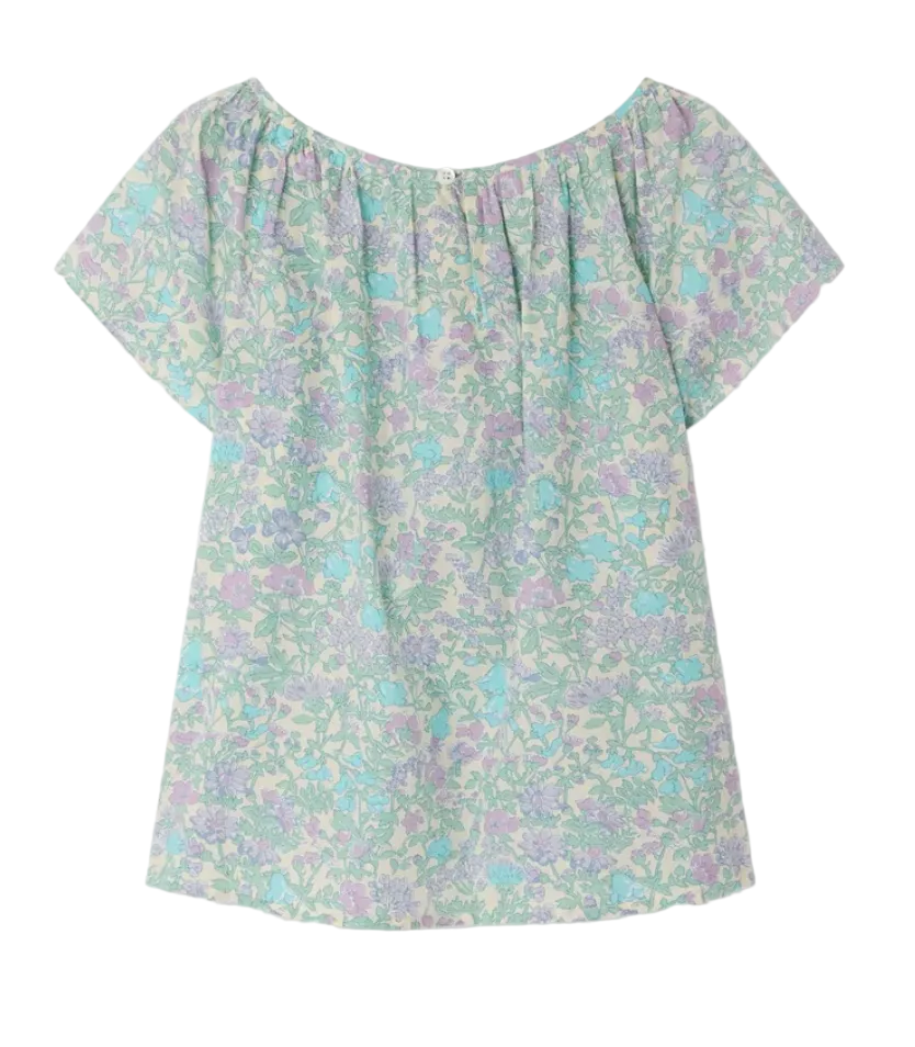 The Bonpoint Girls' Grenade Smocked Blouse is a short-sleeve, off-the-shoulder top made from organic cotton with a light blue, green, and purple floral print on white.