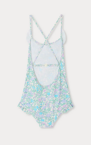 The Bonpoint Girls' Lacy One Piece Swimsuit is crafted from Liberty fabric, features crossed adjustable straps and an open back, and comes in pastel blue, green, and purple floral tones.