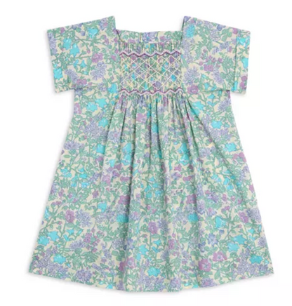 The Girls' Pais Smocked Dress by Bonpoint features short sleeves, a liberty floral print, and smocked detailing across the chest in soft pastel blue, green, and purple shades.