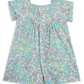 The Bonpoint Girls' Pais Smocked Dress features short sleeves, a button front, and a smocked neckline with a green, purple, and blue liberty floral print, shown laid flat on a white background.