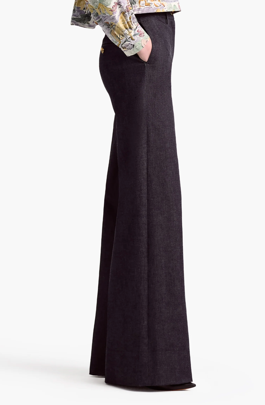 A person wearing the Altuzarra Rudy Pant stands with hands in pockets, shown from the side; only the lower torso and legs are visible.