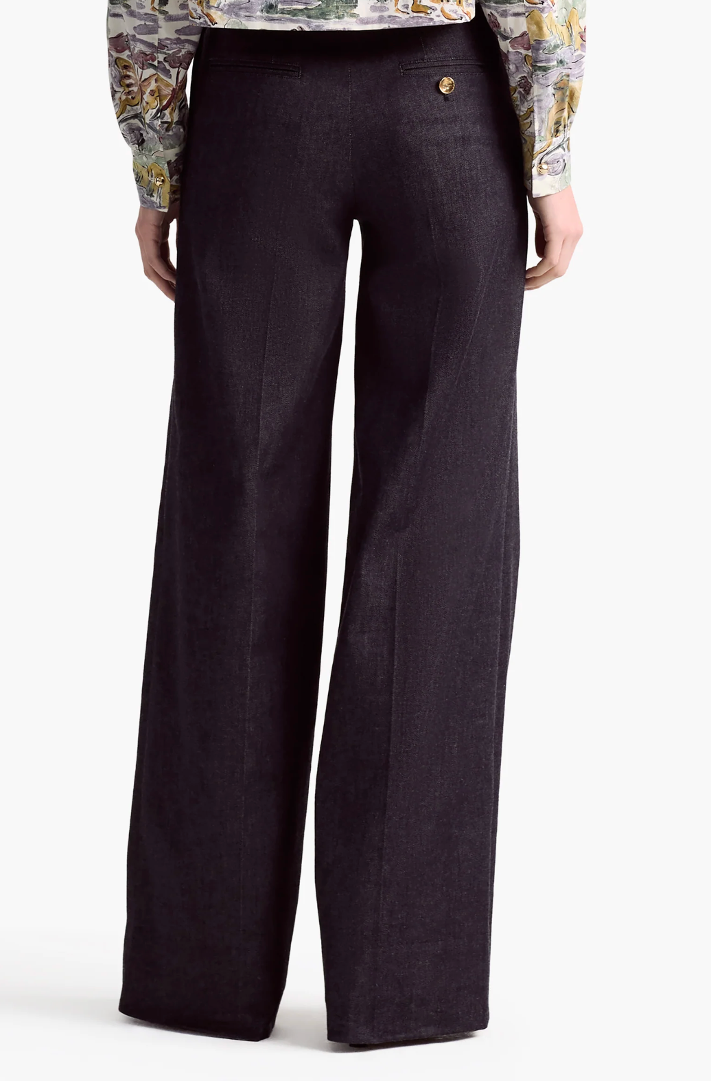 Model shown from the back wearing Altuzarra's Rudy Pant, a black high-waisted wide-leg style, paired with a patterned long-sleeve shirt against a plain background.