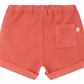 The Baby Boys' and Boys' Ecady Short by Bonpoint, in coral organic cotton, features an elastic waistband, rolled hems, and a right back pocket, shown from the back.