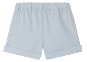 Bonpoint Baby Boys' and Boys' Ecady Shorts in light blue chambray, featuring an elastic waistband and rolled cuffs, shown flat on a white background.