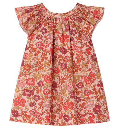 The Bonpoint Baby Girls' and Girls' Carmella Smocked Dress features short sleeves, Liberty fabric with pink, red, orange, and green florals, a gathered neckline, and a loose fit—perfect as a stylish baby dress.