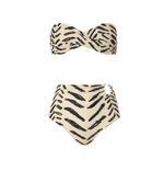 The Sea Sprite & Taita Bikini by Johanna Ortiz is a two-piece set with a strapless twist-front bandeau top and high-waisted bottoms, featuring a cream base with black abstract stripes.