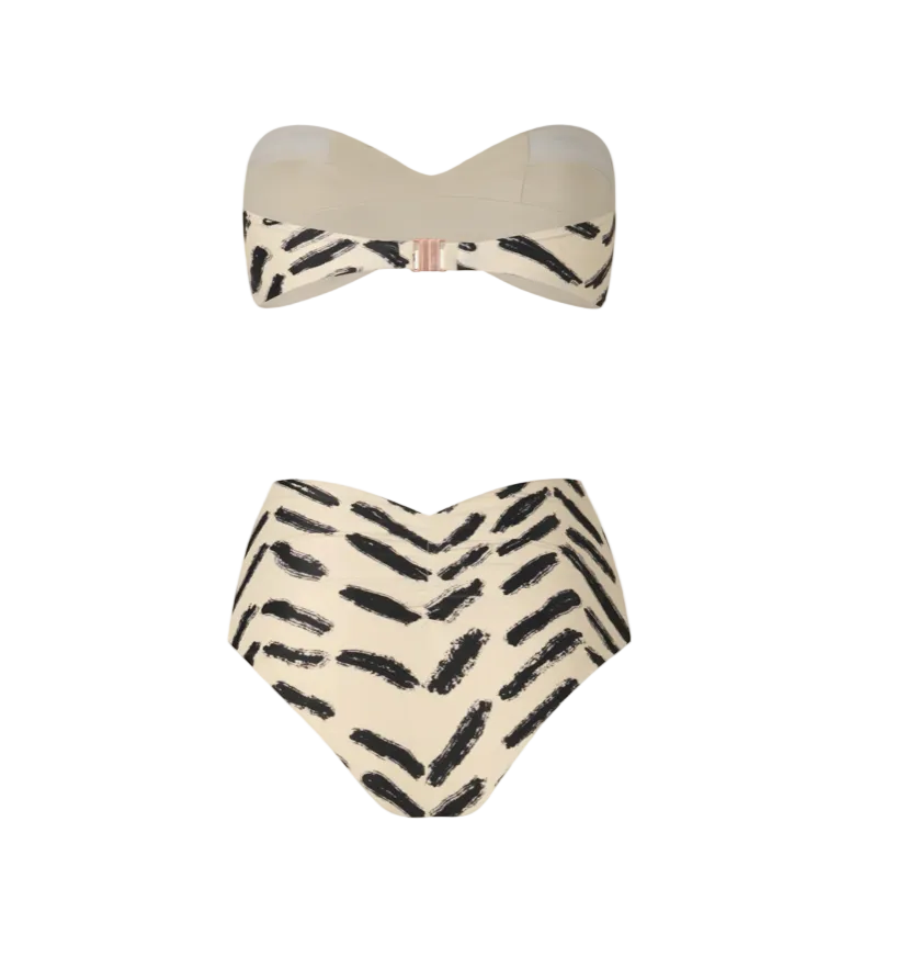 The Johanna Ortiz Sea Sprite & Taita Bikini is a two-piece set with a strapless top and high-waisted bottoms, showcasing a beige base and black brushstroke pattern.