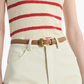 A person wears a sleeveless cream top with red stripes, cream high-waisted pants, and an Altuzarra Square Buckle Belt in tan calf leather.