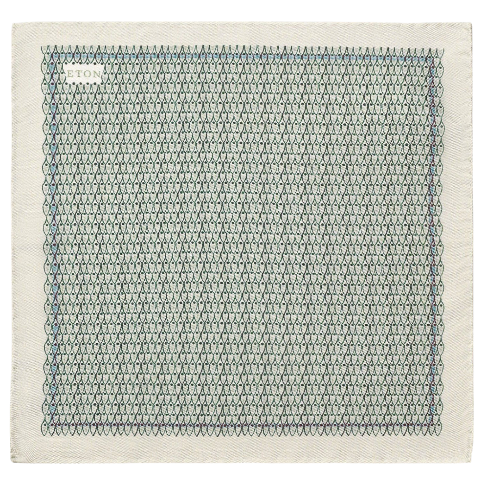 The Geometric Silk Oxford Pocket Square by Eton is an Italian-crafted, square pocket square made from Oxford-woven silk, displaying a repeated geometric pattern of blue and green outlined teardrops and featuring "ETON ATLANTA" subtly printed in small letters in the upper left corner.