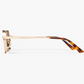 Side view of the Jimmy Fairly Ben eyeglasses, featuring a translucent, gold-toned stainless steel frame with tortoiseshell-patterned acetate sleeves on the temples, set against a plain white background.