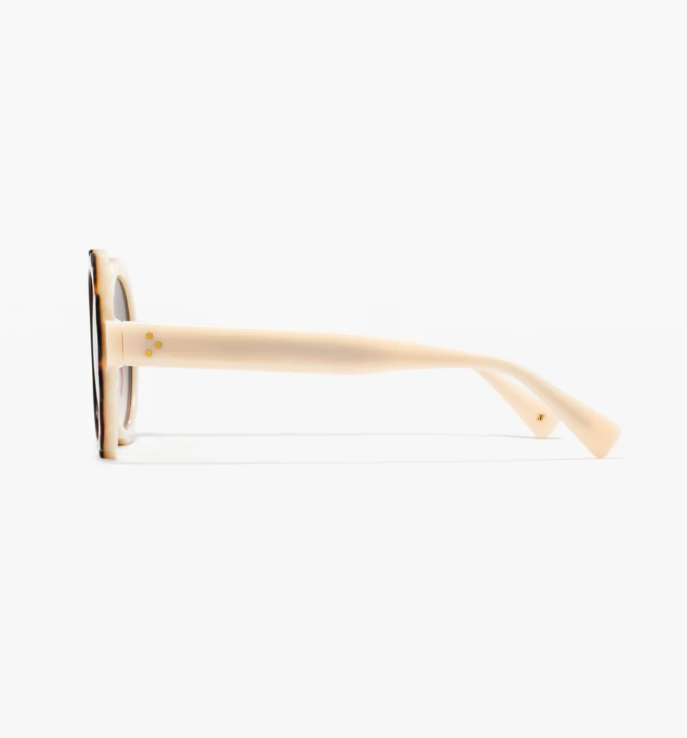 Side view of the Jimmy Fairly Lily sunglasses, featuring a round beige acetate frame with gold dot accents on the arms, displayed against a white background.