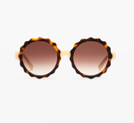 The Lily sunglasses by Jimmy Fairly feature round, wavy brown tortoiseshell acetate frames and gradient brown lenses, shown from the front against a white background.