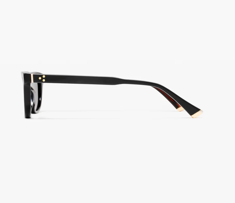 Side view of the Pippa frame by Jimmy Fairly in black cellulose acetate, featuring gold accents on the hinge and temple tip, shown against a plain white background.