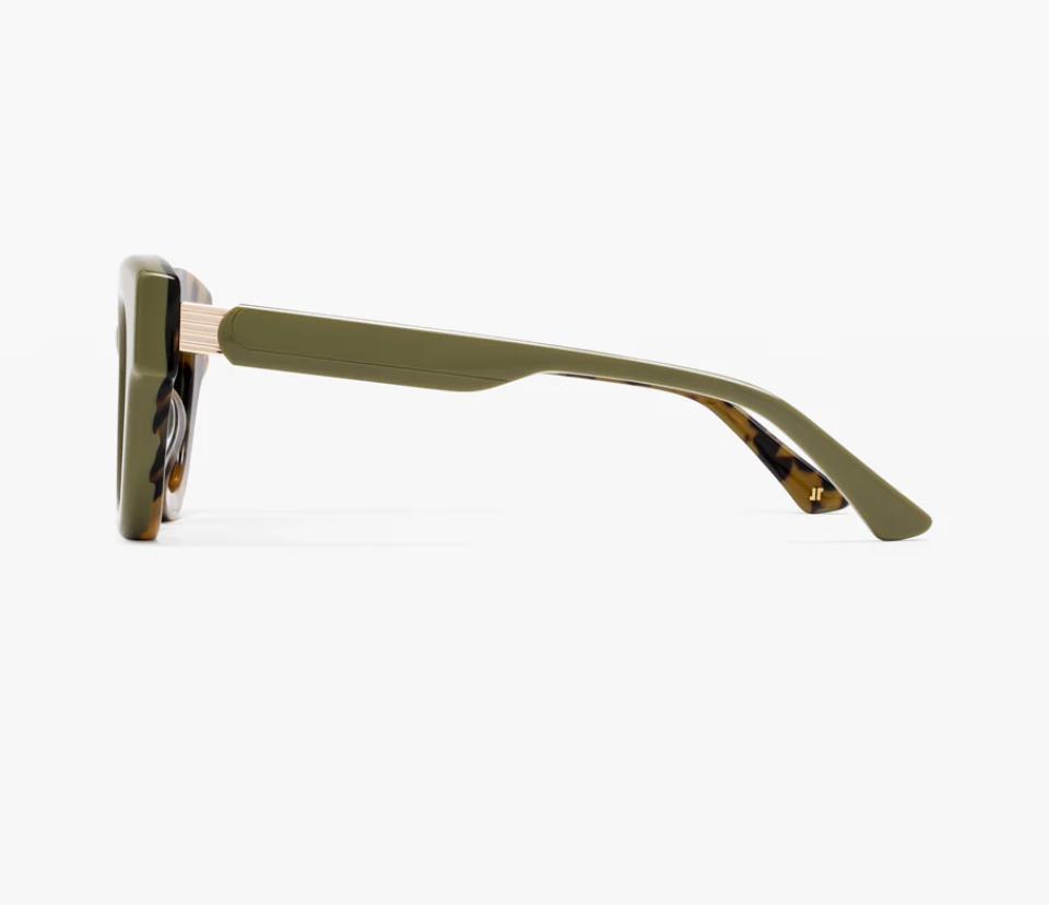 Side view of the Jimmy Fairly Paoli eyeglass frame in olive green cellulose acetate, featuring a thick rectangular arm and a light-colored metal hinge detail, set against a plain white background.
