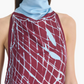 A woman wearing the Altuzarra Moonlight Dress, a sleeveless burgundy piece featuring light blue abstract patterns and a high neckline accented with a light blue scarf-like collar.