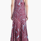 A person wearing the Altuzarra Moonlight Dress—a sleeveless, maroon silk dress featuring a high neckline and light blue abstract lines and patterns—stands with their back to the camera.