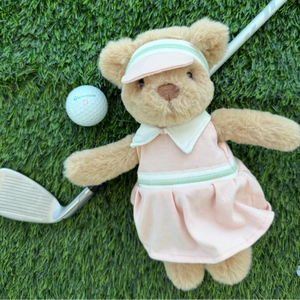 Dressed in a charming pink golf outfit, the Mon Ami Birdie Golf Bear relaxes on the grass beside a golf ball and an iron club, making this adorable golfer teddy bear the ultimate companion for any golf enthusiast.
