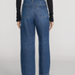 Model wearing The Ranger Pant by Frame—a high-waisted, wide-leg blue jean with a utility pocket—paired with a black long-sleeve top, photographed from the back against a plain background.