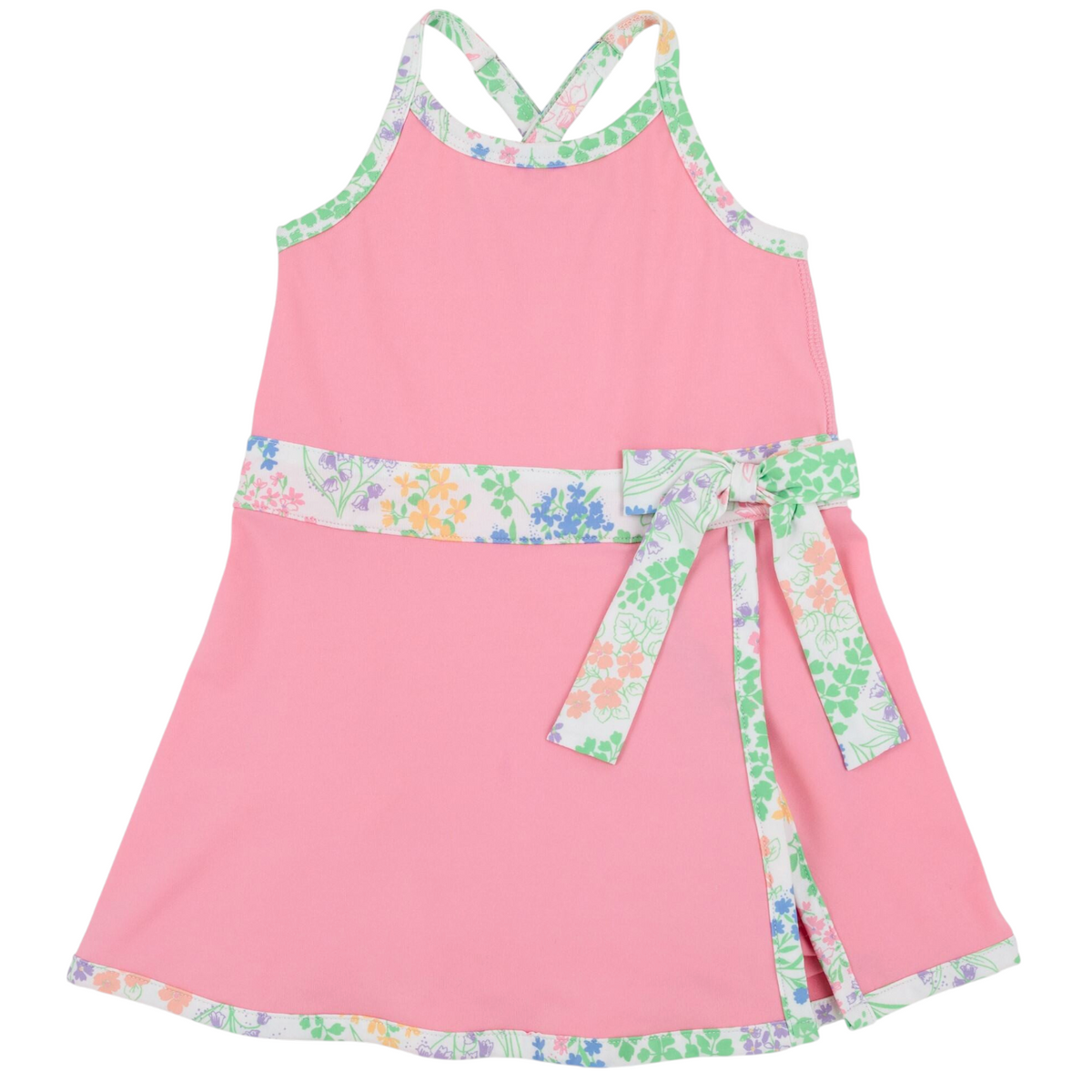 Girls’ Prepletic™ Teggy Tennis Dress by The Beaufort Bonnet Company—a pink sleeveless dress with a floral trim and matching waist sash, featuring a crossover back and floral edging at the hem and neckline for a playful yet polished activewear-inspired look.