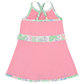 Girls’ Prepletic™ Teggy Tennis Dress by The Beaufort Bonnet Company in pink, featuring floral trim, crisscross back straps, and an A-line silhouette—an ideal choice for girls’ activewear—shown against a plain white background.