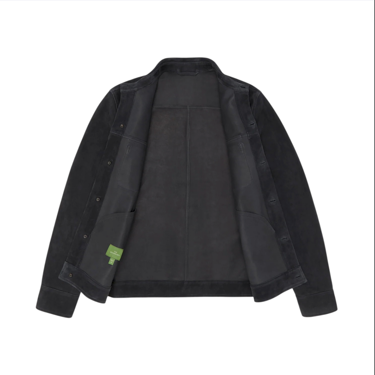 Sid Mashburn’s Work Jacket in black Italian goat suede is shown open against a white background, revealing interior pockets and a green label tag on the inside left pocket—a refined layering piece and versatile work jacket.