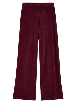 Suzie Kondi Zephyra Velour Pants in deep burgundy with a high-waisted, wide-leg fit and an elastic waistband.