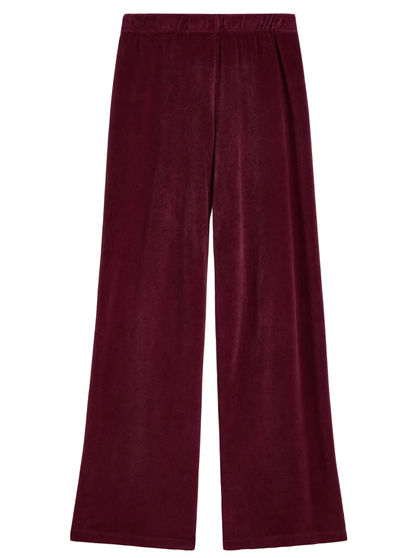 Suzie Kondi Zephyra Velour Pants in deep burgundy with a high-waisted, wide-leg fit and an elastic waistband.