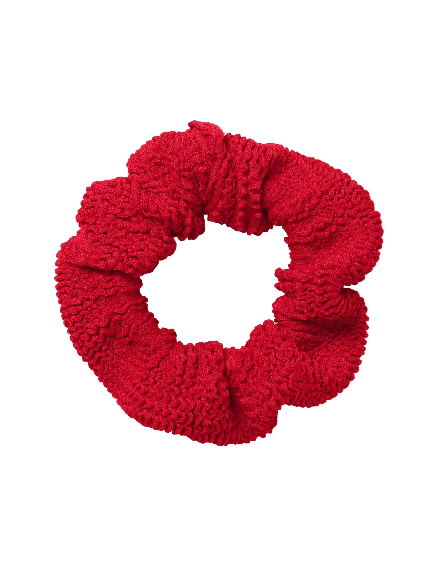 The Hunza G Scrunchie in red textured fabric is displayed on a white background—an ideal way to add vibrant color to your hair accessories collection.