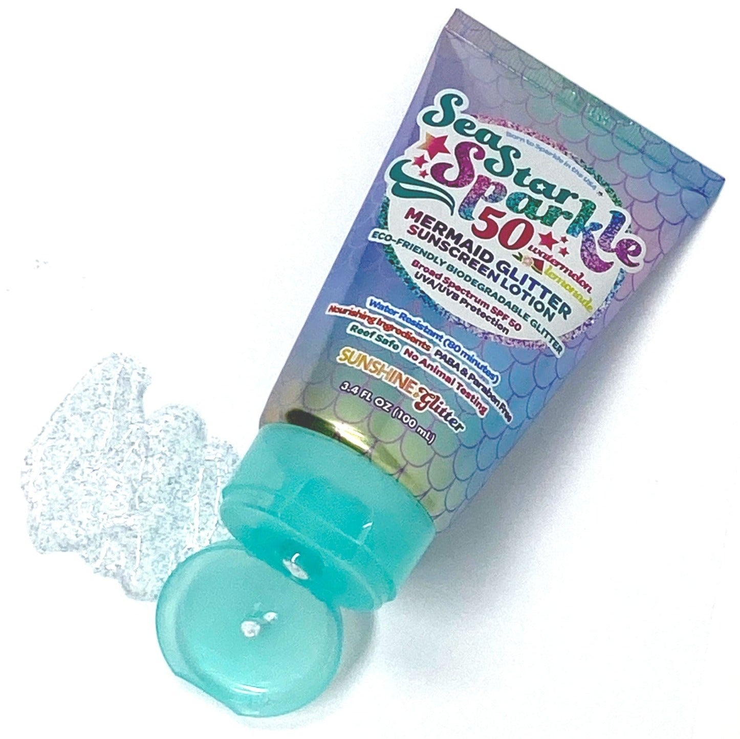 A tube of Sunshine Glitter Sea Star Sparkle SPF 50 Sunscreen with a smear of the product beside it. The tube, offering superior UVA/UVB protection and water resistance, is decorated with a pastel scale pattern and has a blue cap.