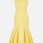 The Emilia Wickstead Seema Dress is a sleeveless, fitted yellow summer wool dress with a flared trumpet-style hem, shown against a plain white background.