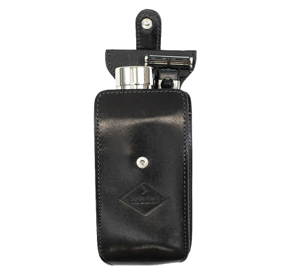Barberino's Travel Set: black leather case with snap closure, includes a travel razor and metal container, displayed open against a plain background.