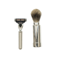 The Barberino's Travel Set, featuring a silver-handled razor and a luxury badger hair shaving brush, is displayed side by side on a white background.