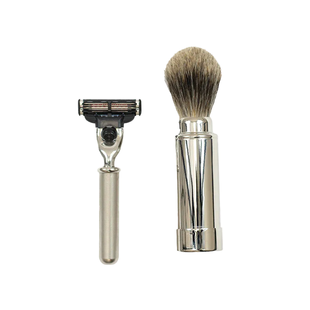 The Barberino's Travel Set, featuring a silver-handled razor and a luxury badger hair shaving brush, is displayed side by side on a white background.