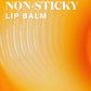 Text reads “Supergoop Glow Gloss Lip Balm SPF 40 - Strawberry Spritz: Sheer coral tint delivers ultra-hydrated, high-shine, non-sticky lips” over a bright orange-yellow abstract background.