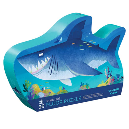 Dive into the colorful ocean realm with Crocodile Creek's Shark Reef 36 Piece Puzzle. This jigsaw for kids showcases a captivating illustration of a shark amidst vibrant marine life, providing an engaging and educational experience with every piece.