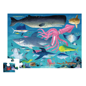 Explore the Crocodile Creek Shark Reef 36 Piece Puzzle, featuring a vibrant ocean theme with sea creatures such as sharks, a whale, and a squid set against the lively backdrop of the ocean floor. Keep in mind—one piece is missing from the lower left corner!